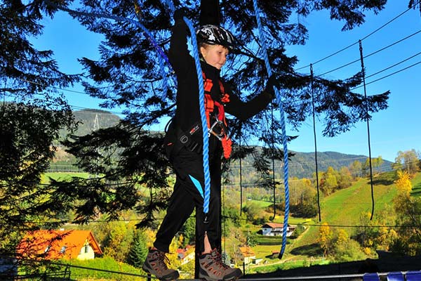 Mädchen klettert im Klettergarten am Stuhleck